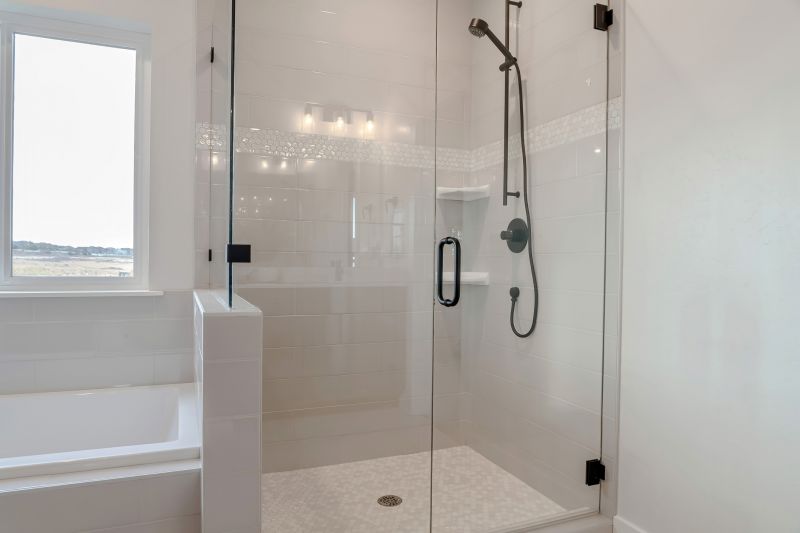 Glass shower enclosure with modern fixtures